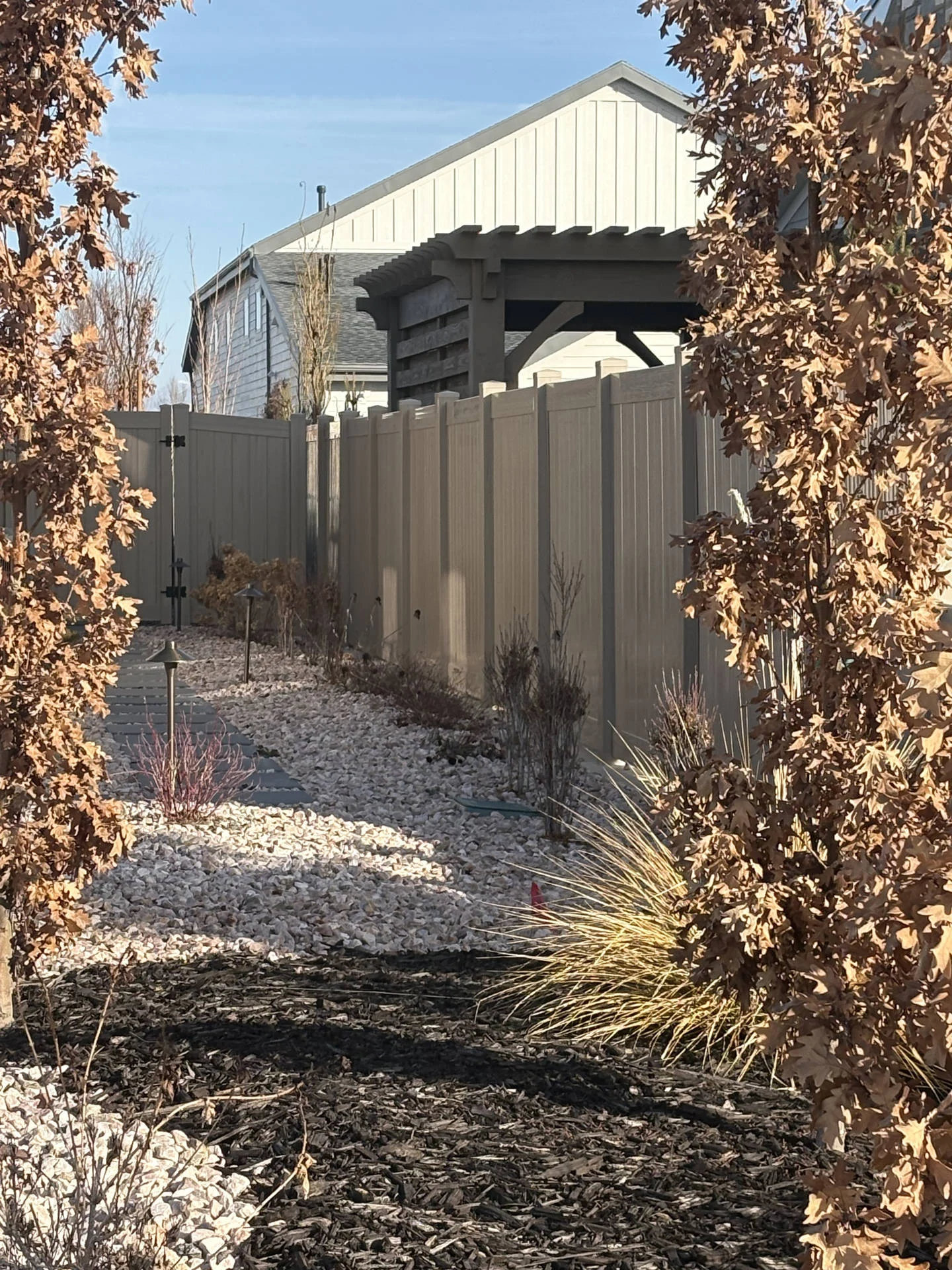 Driftwood Vinyl Fence with Steel Accents & Mow Strip