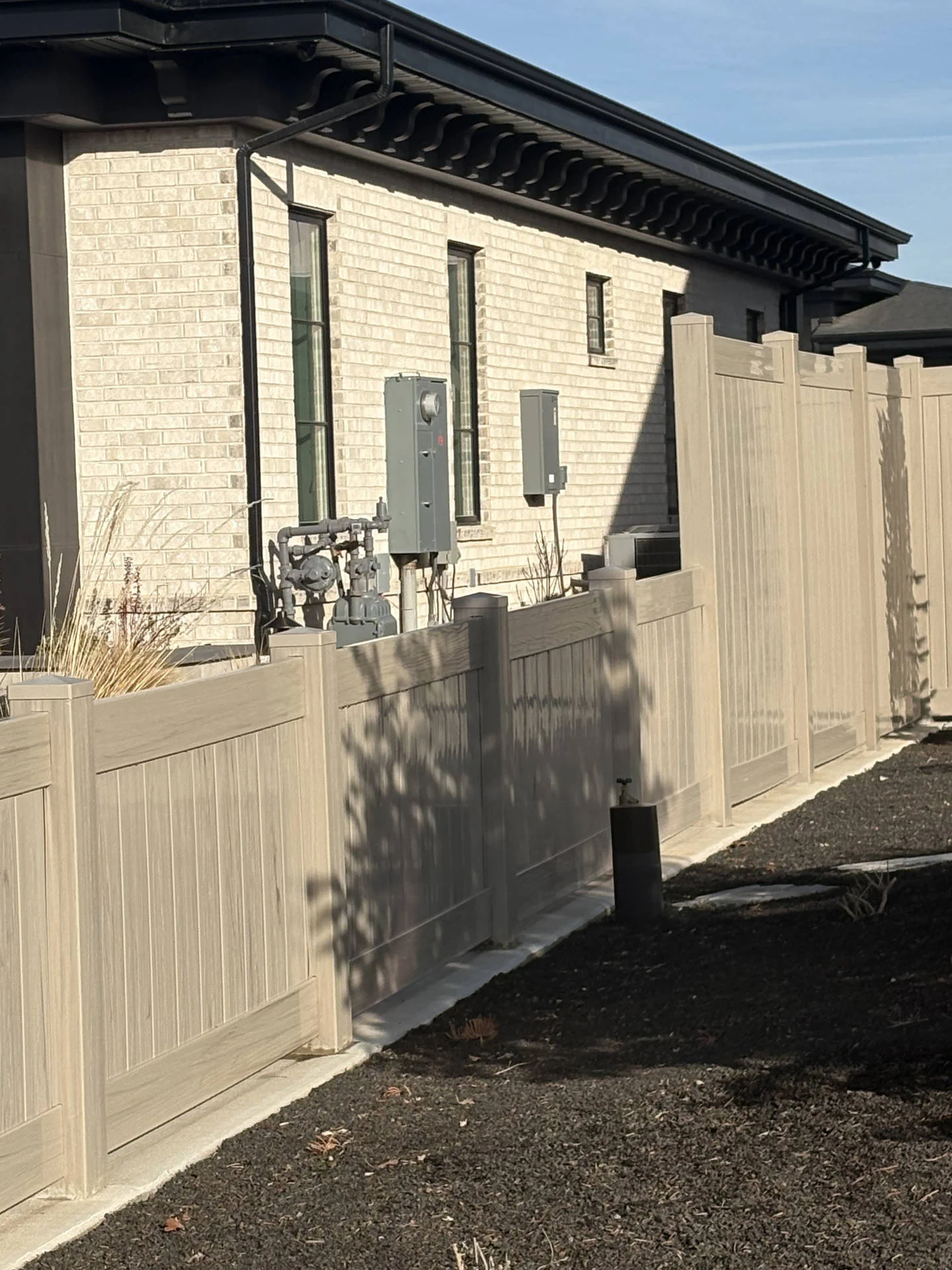 Driftwood Vinyl Fence with Steel Accents & Mow Strip